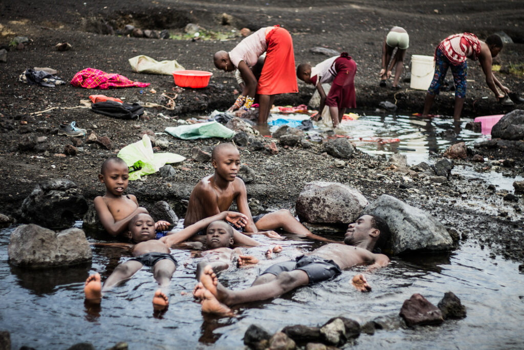 Shot at the shores of Lake Elementaita in Naivasha, Kenya, Kennedy and the boys bask in the warm waters, behind women are busy washing clothes.