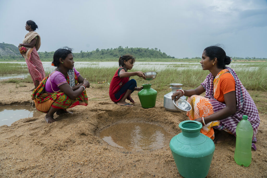 In West Bengal, India, the arduous task of collecting drinking water falls primarily on women and girls, who often journey miles to newly dug sandpits for this vital resource.