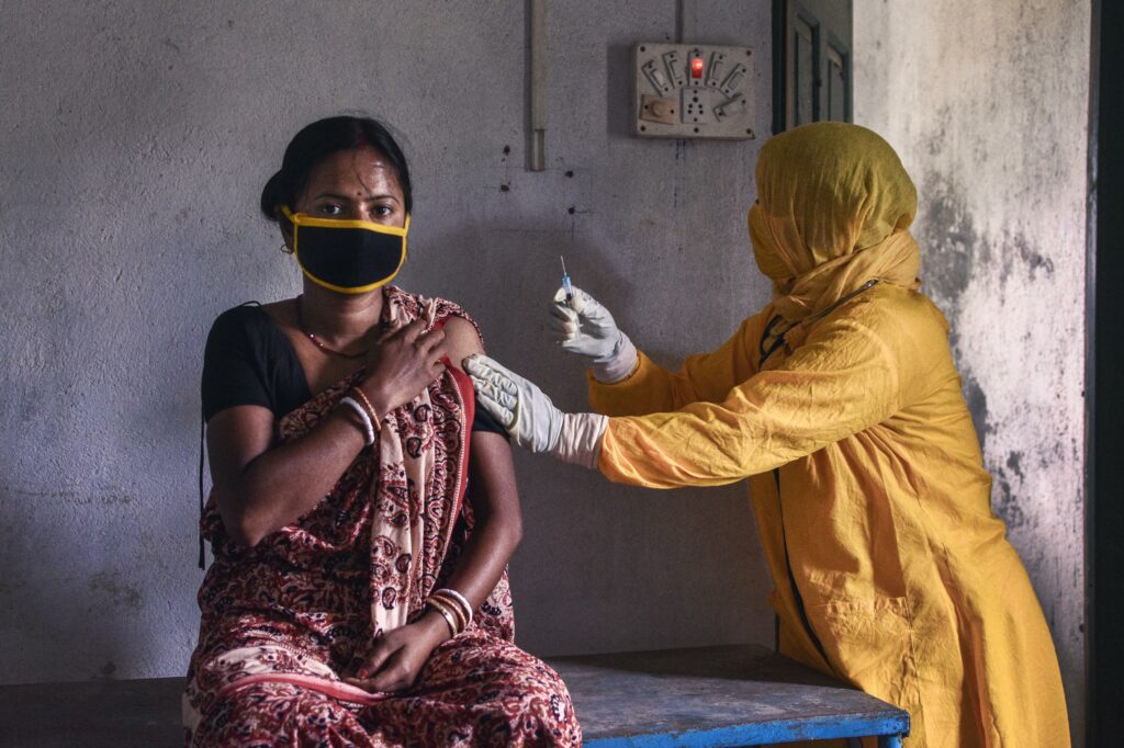 A healthcare worker gives an tetanus injection to a pregnant woman at her clinic on the remote island of Sunderban, India.